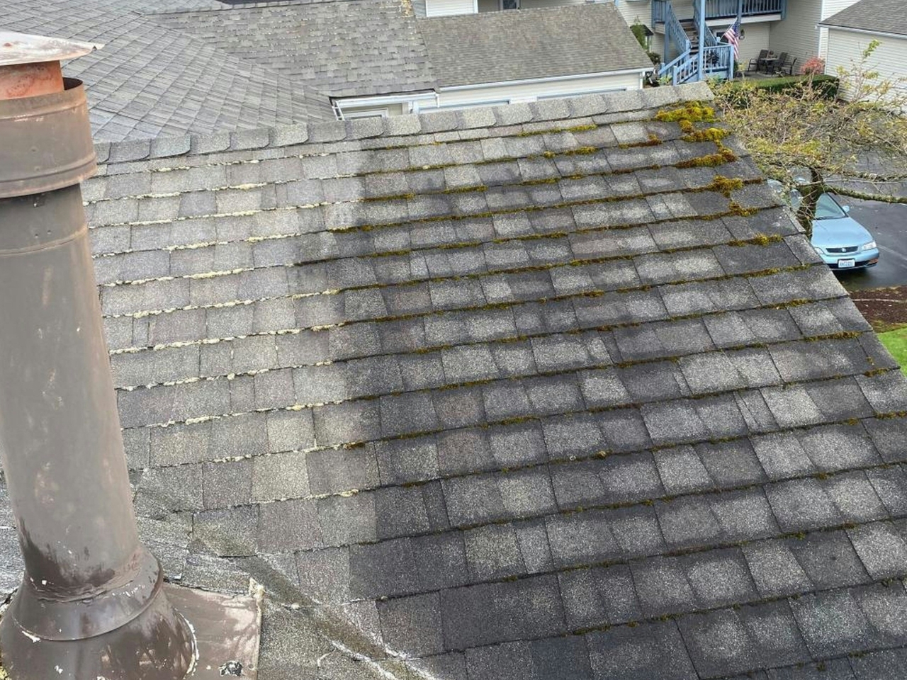 Roof repair in progress with a professional inspecting shingles for damage